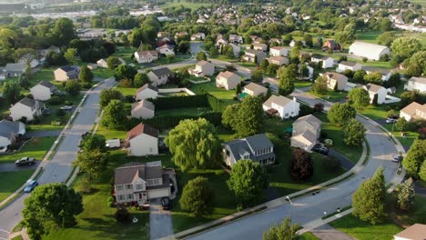 Establishing-shot,-aerial-of-neighborhood-community-with-two-story-colonial-homes-during-summer-magic-hour,-housing-development-in-United-States-of-America,-USA