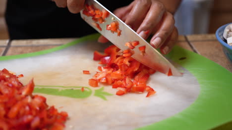 Dicing-and-chopping-fresh-red-bell-peppers-to-add-to-a-vegetarian-recipe---slow-motion
