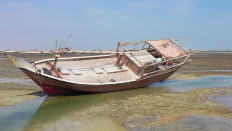 Fishing-boat-sitting-on-dry-land-at-low-tide