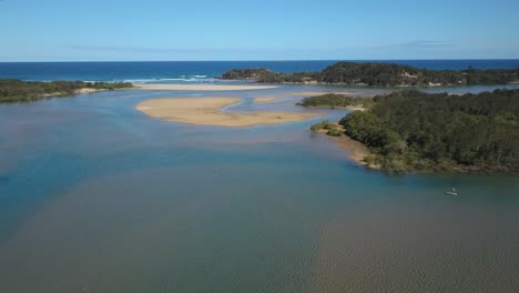 Man-on-sup-stand-up-paddle-on-Corindi-River,-Australia
