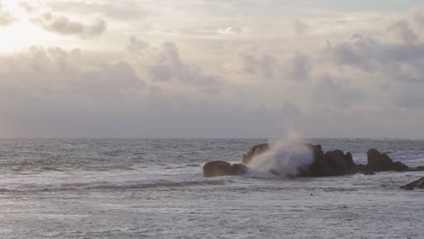 Sea-Waves-Crashing-on-to-rocks-in-distance,-evening-Galle-fort-Seashore-Slow-mo-b-roll-clip