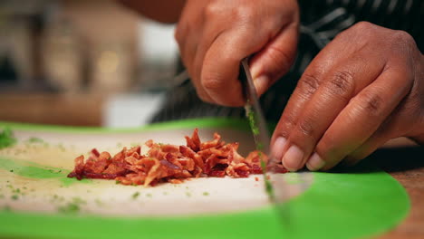 Chopping-fried-bacon-into-bits-to-top-off-a-delicious-homemade-recipe---slow-motion