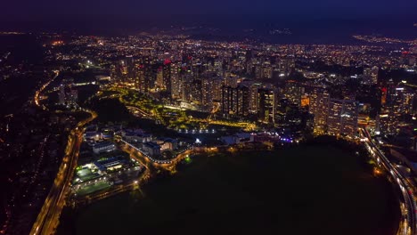 Aerial-night-hyperlapse-city-skyline-La-Mexicana-park-and-lights-at-dusk