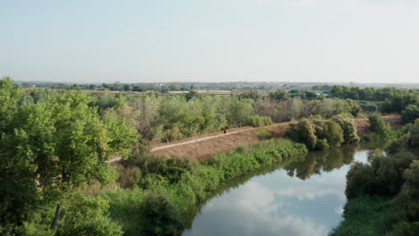 Madrid---Outdoor-Jogging---Running-Trail-by-River-in-Spain-Countryside,-Aerial-Drone-View