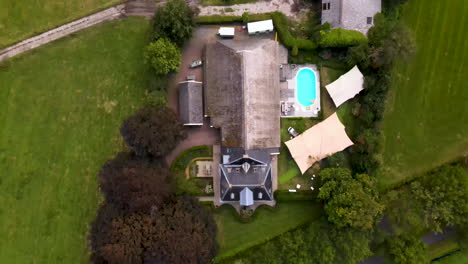 Drone-flying-over-villa,-revealing-beautiful-Dutch-landscape