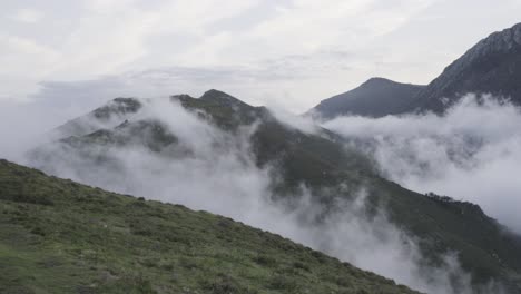 Time-Lapse-clouds-in-the-valley,-mountains-at-the-background,-cloudy-sky,-meadow,-static-shot