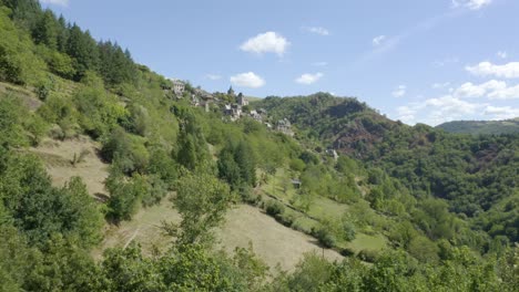 La-Vinzelle-aerial-view-of-french-woodland-mountain-small-town-rising-dolly-right