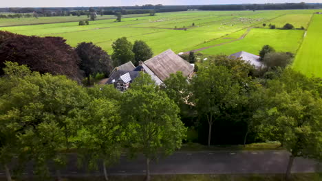 Aerial-of-beautiful-farmhouse-in-meadows-in-rural-Netherlands