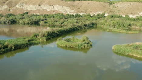 Marshland-River-in-Lush-Rural-Landscape---Aerial-Drone-4k