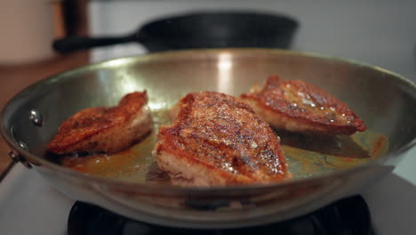 Frying-chicken-breasts-in-a-stove-top-skillet-and-watching-them-sizzle-in-slow-motion