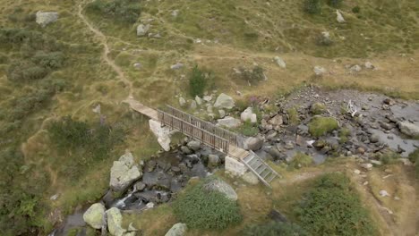 Panoramic-view-of-a-little-cute-bridge-and-a-river-on-the-mountains-in-La-Cerdanya