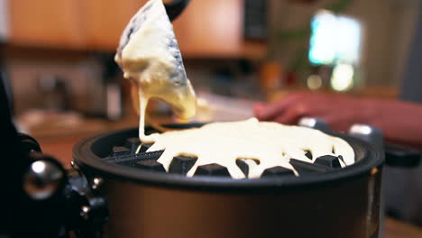 Adding-more-batter-to-the-waffle-iron-for-a-delicious-breakfast---slow-motion-isolated