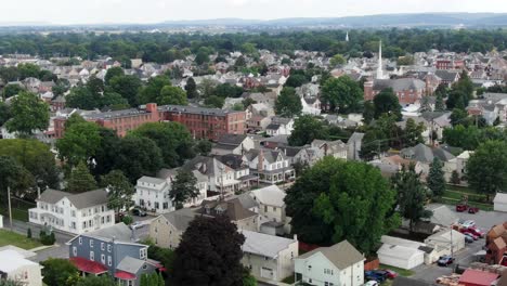 Aerial-establishing-shot-of-small-town-rural-America,-historic-homes,-colorful-houses-line-street,-summer-time-view-of-Anytown-USA,-United-States-of-America,-friendly-quiet-neighborhood-community