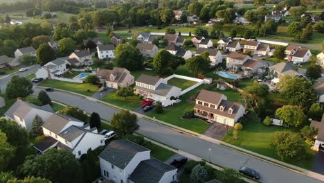 Traditional-colonial-homes-in-United-States-of-America,-American-suburb,-aerial-orbit-shot-during-summer,-small-town-American-community-neighborhood-development
