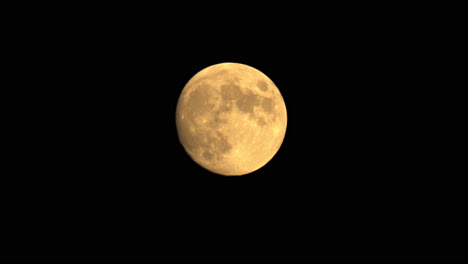Isolated-Large-Full-Moon,-Illuminated-Orange-Against-Night-Sky