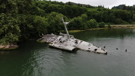 Aerial-orbit-around-USS-Plainview-shipwreck-in-Columbia-River-coastline-on-cloudy-day