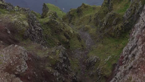 Astounding-Overhead-View-Of-The-Latrabjarg-Cliff,-A-Coastal-Promontory-In-Iceland-With-Birds-Flying---aerial-drone