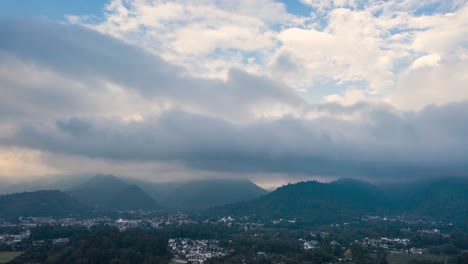 Aerial-Drone-Hyperlapse-of-clouds-creating-rain-and-between-the-mountains-in-Antigua-Guatemala