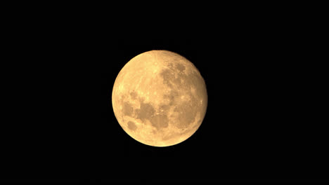 Time-Lapse-Of-Large-Orange-Full-Moon-Glowing-Bright