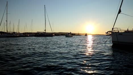 Boats-and-yachts-enter-and-exit-marina-at-sunset-in-Biograd-in-Croatia