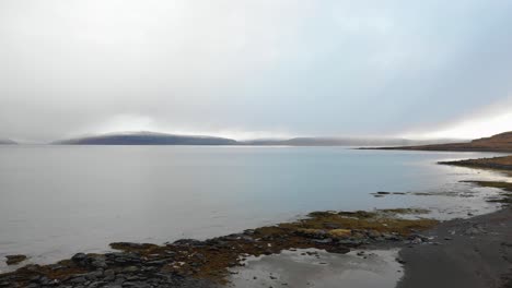 Drone-Flies-Low-over-Epic-Rocky-River-coast-in-the-Westfjords-on-an-Overcast-Day
