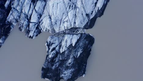 Top-down-View-Of-The-Snowy-Solheimajokull-Glacier-In-Iceland---Famous-Tourist-Attraction---aerial-drone