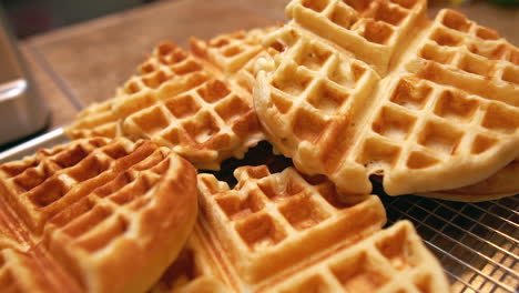 Freshly-made-waffles-cooling-and-ready-for-a-big-family-breakfast-feast---push-forward-close-up