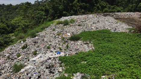 Aerial-drone-shot-of-Landfill-meets-jungle-garbage-dump-on-a-tropical-Island