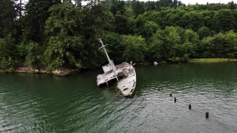 Aerial-zoom-out-of-shipwreck-of-USS-Plainview-military-boat-on-Columbia-River-coast