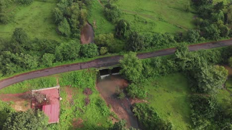 small-village-road-bridge-over-river-drone-