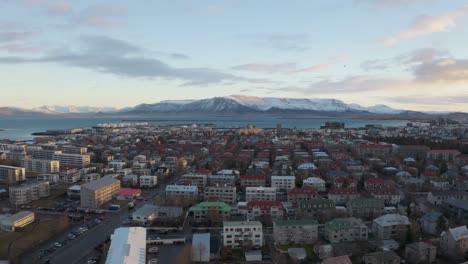 Aerial-view-above-nordic-capital-of-Iceland-Reykjavik,-sideways-dolly,-sunset