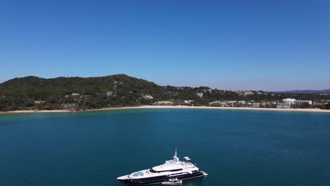 Tourists-on-a-luxury-yacht-by-the-beach-of-the-Sunshine-Coast---Queensland-Australia