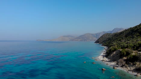 Beautiful-seaside-panorama-with-rocky-mountains-washed-by-blue-turquoise-Ionian-sea