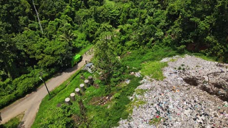 Aerial-down-pan-drone-shot-of-a-tropical-island-trash-dump
