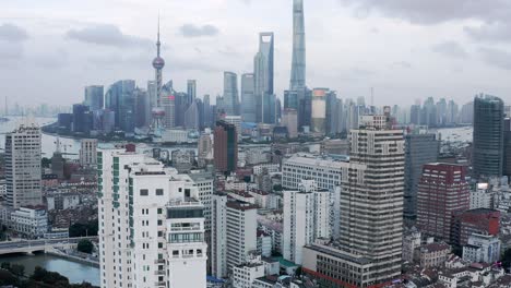 Downtown-Shanghai-city-skyline,-rising-aerial-view-over-towers