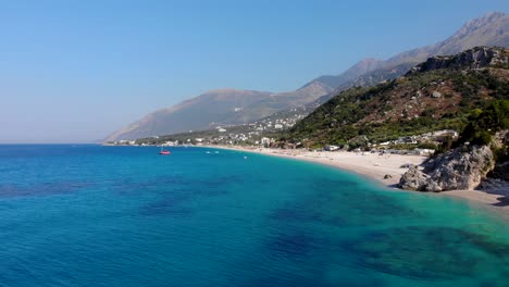 Paradise-beach-on-a-remote-tranquil-coastline-in-Mediterranean-surrounded-by-rocks-and-azure-sea-water