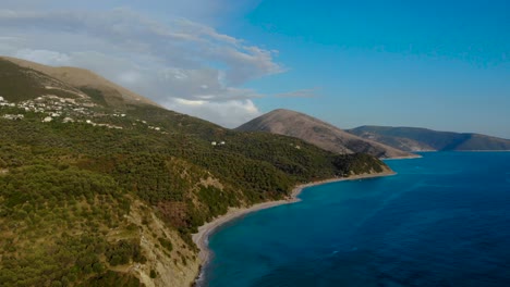 Panoramic-seaside-on-Mediterranean-with-mountains-and-olive-trees-hills-surrounded-by-blue-azure-sea-water