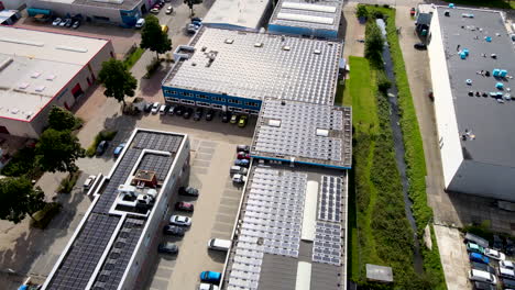 Jib-down-of-rooftop-filled-with-solar-panels-on-busy-industrial-terrain