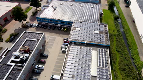 Aerial-of-rooftop-filled-with-solar-panels-on-busy-industrial-terrain