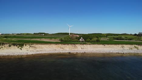 4K-Luftaufnahme-Der-Dänischen-Küste-Mit-Einer-Kleinen-Klippe-Und-Grünen-Feldern