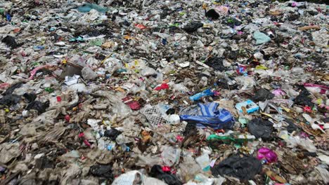 Aerial-downward-tilt-dolly-shot-of-a-waste-management-landfill-site-in-Thailand