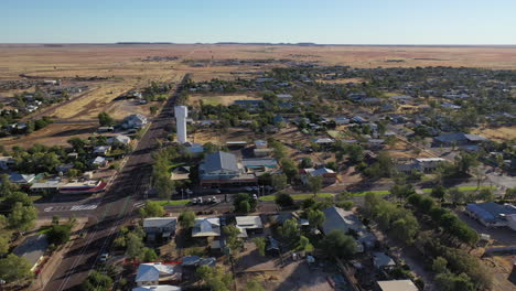 Aerial:-Drone-shot-panning-in-a-left-arc-to-reveal-more-of-the-town-of-Winton,-in-QLD-Australia