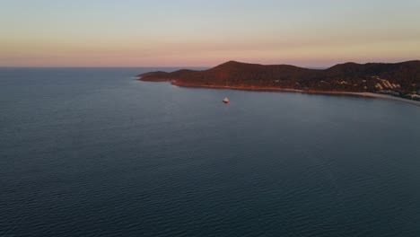 Luxury-Yacht-Floating-On-The-Calm-Water---Noosa-National-Park-During-Sunrise---Brisbane,-QLD,-Australia