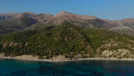 Mediterranean-coastline-with-hills-and-mountains-surrounded-by-turquoise-sea-on-summer