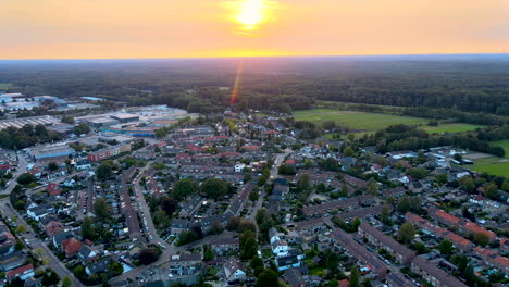 Aerial-of-beautiful-town-in-rural-area-with-the-sun-setting-in-the-background