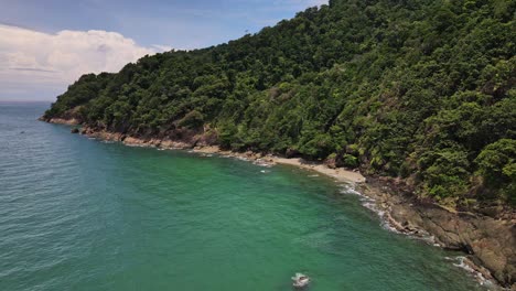 Static-drone-shot-of-Tropical-Island-coastline-with-small-secluded-beach