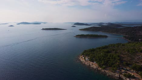 Stunning-aerial-view-flying-forward-across-coastline-of-Dalmatia,-Croatia-filmed-in-4k-with-clear-water,-beaches-and-rocky-shore-of-the-Adriatic-Sea