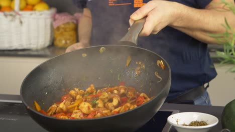 A-cook-tossing-ingredients-in-the-cooking-pan-with-some-professional-tricks-in-slow-motion