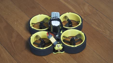 Close-up-shot-of-FPV-drone-BumbleBee-CineWhoop-with-LiPo-battery-plugged-in
