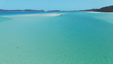 Fantastic-Fast-Drone-Flying-over-Four-People-Enjoying-the-Most-Beautiful-Beach-in-the-World,-White-Haven-Beach,-Queensland